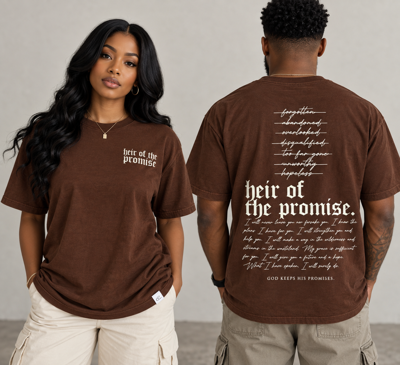 A man and a woman modeling a brown short-sleeve graphic T-shirt, showing both the front and back views. The front features the text 'heir of the promise' in white on the left chest, while the back displays a long white script and block text design with the same phrase as the heading.