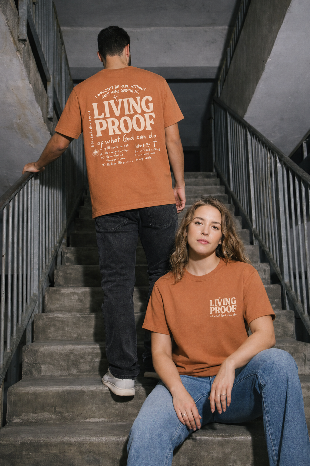 Two people wearing 'Living Proof' t-shirts on a staircase.